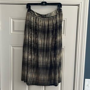 Shin length pleated black and gold metallic skirt